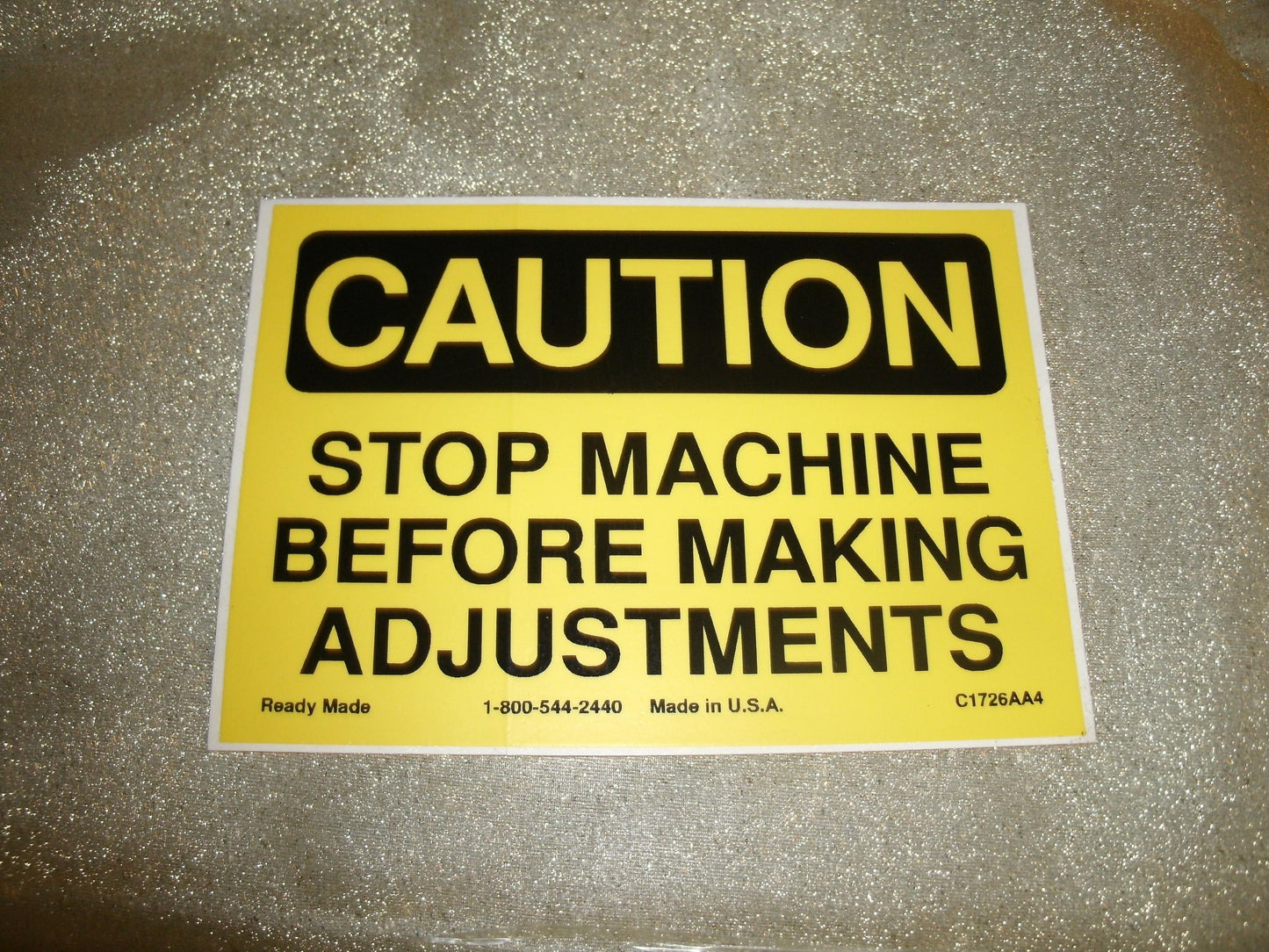 CAUTION Stop Machine Before Making Adjustments Sign.